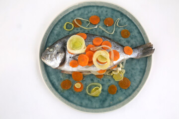 dorada fish with carrots and leeks as sea food