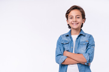 Happy young caucasian boy in casual outfit with arms crossed isolated over white background - Powered by Adobe