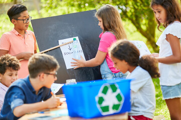 Children learn recycling in an ecology project - Powered by Adobe