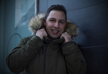 attractive young man with anorak on the black wall © tetxu