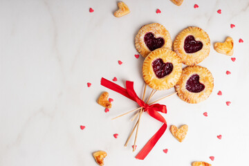 Small cherry pies pops on sticks on Valentine's Day. Place for text or advertising.