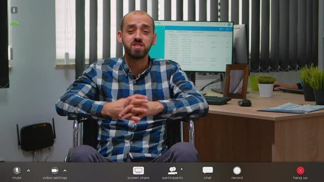Disabled businessman in wheelchair waving at videocall having online conference in business office. Paralysed freelancer working remotely having virtual discussion, footage with software overlay