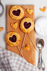 Small cherry pies pops on sticks on Valentine's Day. 