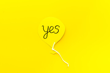 Yes agreement - decision concept. Word Yes on paper banner, top view