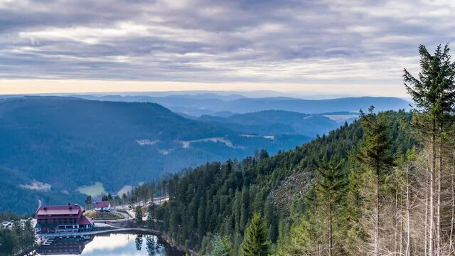 Time lapse, sun shining through clouds on hillside, Mummelsee in Baden, Germany