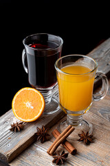 Seasonal hot beverages on wooden rustic table with ingredients on it, top view