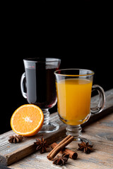 Seasonal hot beverages on wooden rustic table with ingredients on it, top view