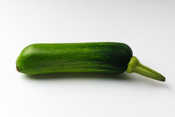 Elongated zucchini on white background