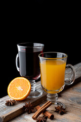 Buckthorn tea and berry tea with cinnamon and honey on wooden table, cozy autumn atmosphere