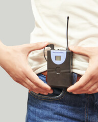 Men in translation center. Set for telemarketing. Male manager customer. Listening operator. Studio portrait. Person multi language translator. Grey background. Hand hold multy guide. Casual t-shirt