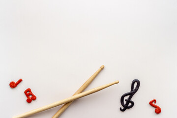 Drum sticks with music notes, overhead view. Music background