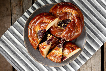 Buns with jam on a wooden table. Pie with cherry jam and marzipan. Rustic delicious pastries