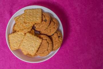 Breakfast cookies are on a platter. Pink background. Copy space.