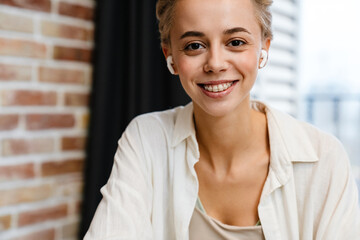 Smiling young woman on a video call via laptop