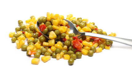 Mexican salad and metal spoon, vegetables mix with corn, peas and paprika isolated on white background