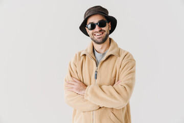 Portrait of man wearing beige jacket, cap and sunglasses