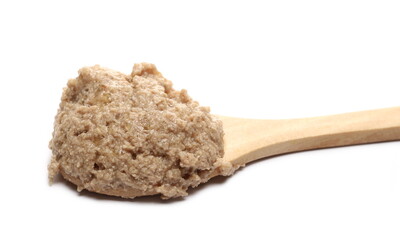 Cat food with chicken ingredients and wooden spoon isolated on white background