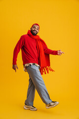 Excited happy african man wearing scarf walking