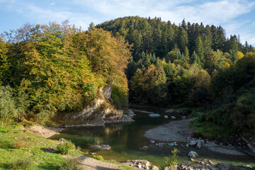 Two lovers embracing on top of a hill overlooking the river, Romantic setting, Couple of newlyweds on the banks of a mountain river.