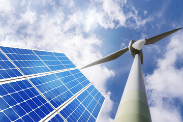Solar panels and wind turbines with blue sky