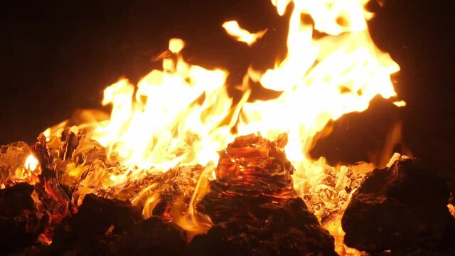 Close-up of burning flames at night, burning paper in the dark