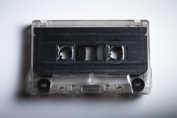 Close-up of a classic audio cassette tape with magnetic tape inside. Retro background