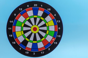 Colored dartboard, on a blue background foreground. Darts without darts. Successful strategy concept.