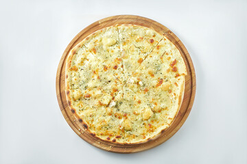 Classic italian pizza with 4 types of cheese on a wooden tray on a white plate