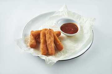 A classic beer snack is deep-fried mozzarella cheese sticks in a white plate. White background