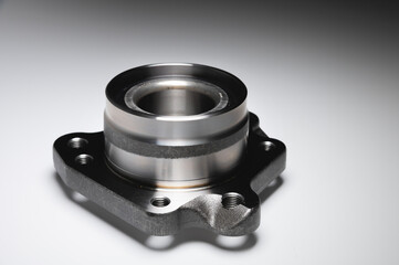 New wheel bearing in a metal housing on a black-white gradient background. New car suspension parts