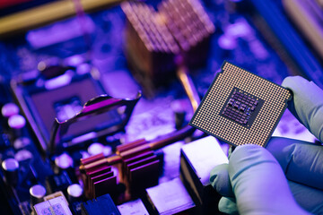 Fototapeta Engineer showing a computer microchip on motherboard background. Electronic circuit board with processor obraz