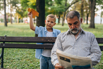 Fototapeta premium grandfather and grandson enjoying time in public park