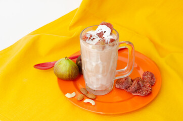 Anjeer Shake or  Fig Milk Shake with Cream,  fresh Fig Pieces and Dry Fruit.  Top Angle View,  Studio Shot