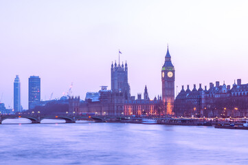 Fototapeta na wymiar dusk landmark of london westminister parlaiment building across thames river with plain sky background