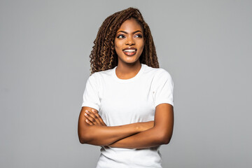 Obraz premium Joyful African American student keeps hands crossed isolated over white background.