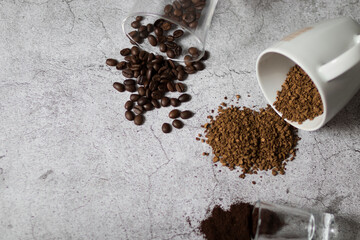 
Instant coffee, coffee beans and ground coffee.All this on a gray background