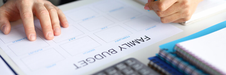 Close-up of couple accounting family budget. Paper for planning wastes on every month. Man and...