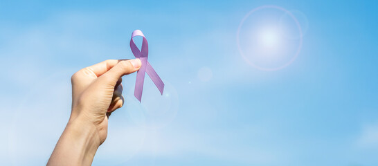 World cancer day (February 4). Woman hand holding Lavender purple ribbon for supporting people...
