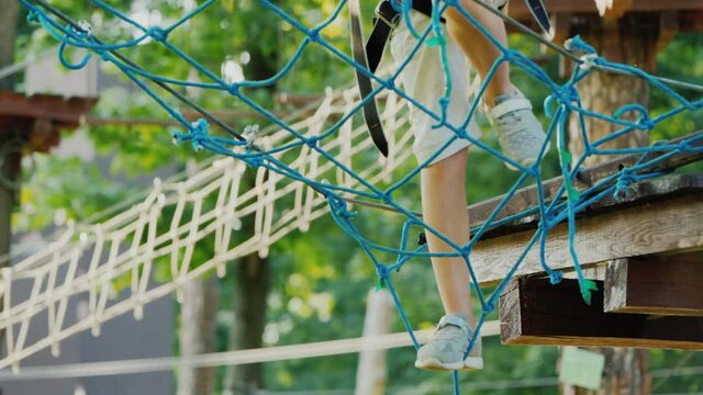 Feet strode on a rickety grid stretched high above the ground