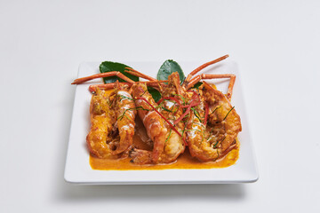 Fried prawn with curry paste served on a white plate Popular seafood dishes