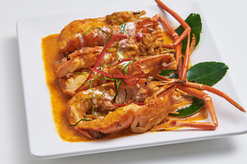 Fried prawn with curry paste served on a white plate Popular seafood dishes