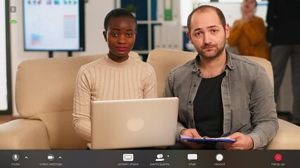 POV of diverse colleagues discussing about financial strategy during video meeting using webcam sitting on couch in start up office. Coworkers analysing reports, footage with software overlay concept - Powered by Adobe