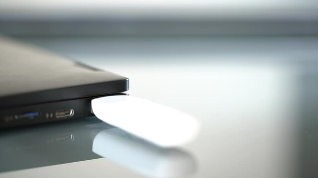 Hands connecting pendrive to blue usb port