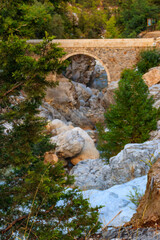 Ancient stone bridge across a mountain river in Kesme Bogaz canyon, Antalya province in Turkey