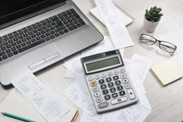 Bills and calculator with checks for goods and services.. calculator to calculate bills at the table in office. Calculation of costs.