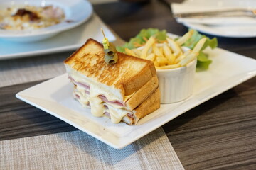 piece of sandwich with ham and cheese