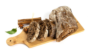 Fresh homemade sliced ciabatta bread on a kitchen board with cinnamon sticks on a white plate.