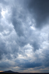 Stormy sky with storm clouns on the sunset with beautiful sun