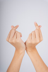 Woman hand posing mini heart gesture with two hands isolate over white background.