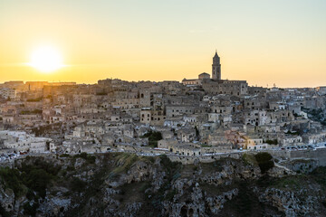 Fototapeta premium The sun setting behind Sassi di Matera historic district, Basilicata, Italy